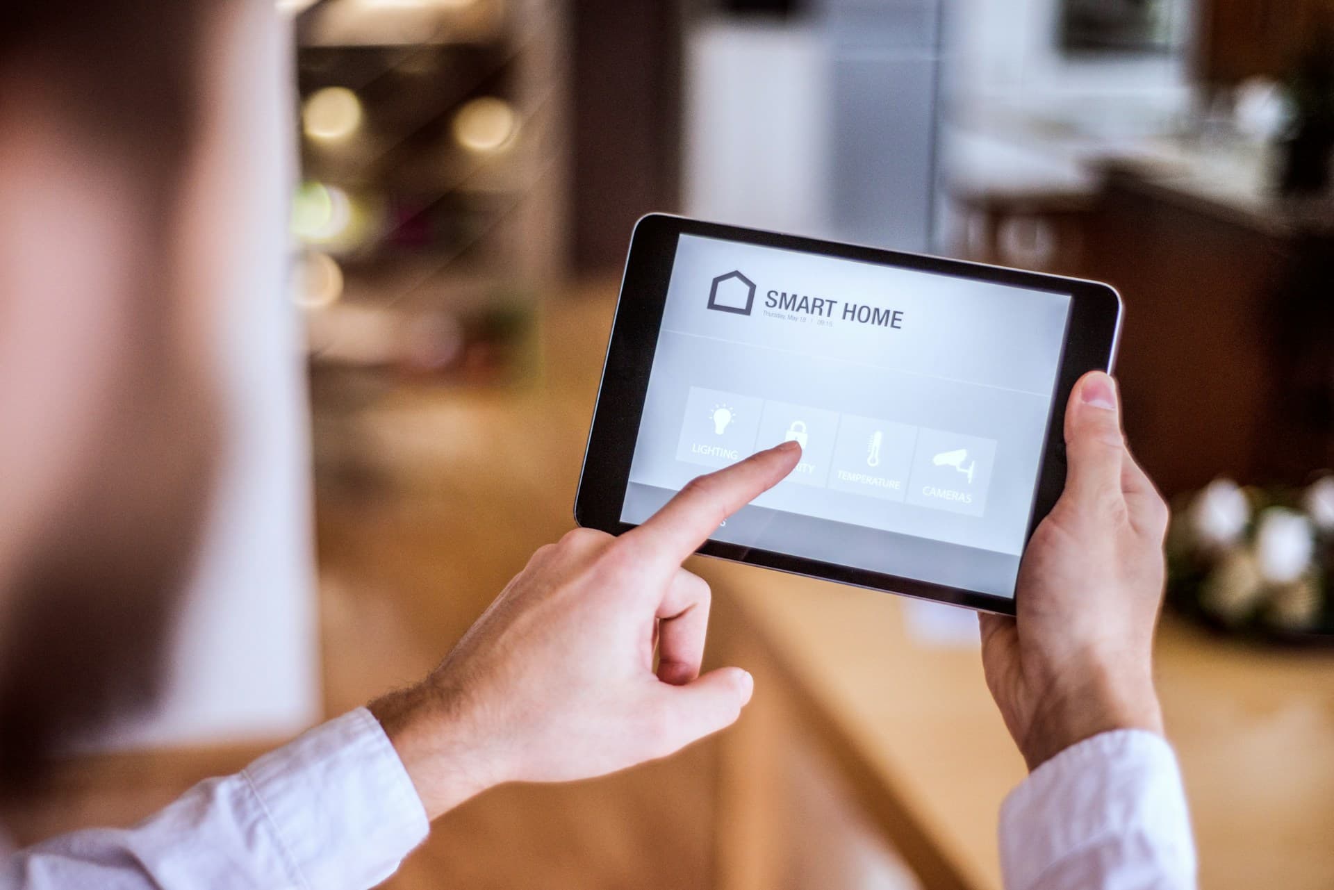 Person using a smart home app to control switches in a modern living room